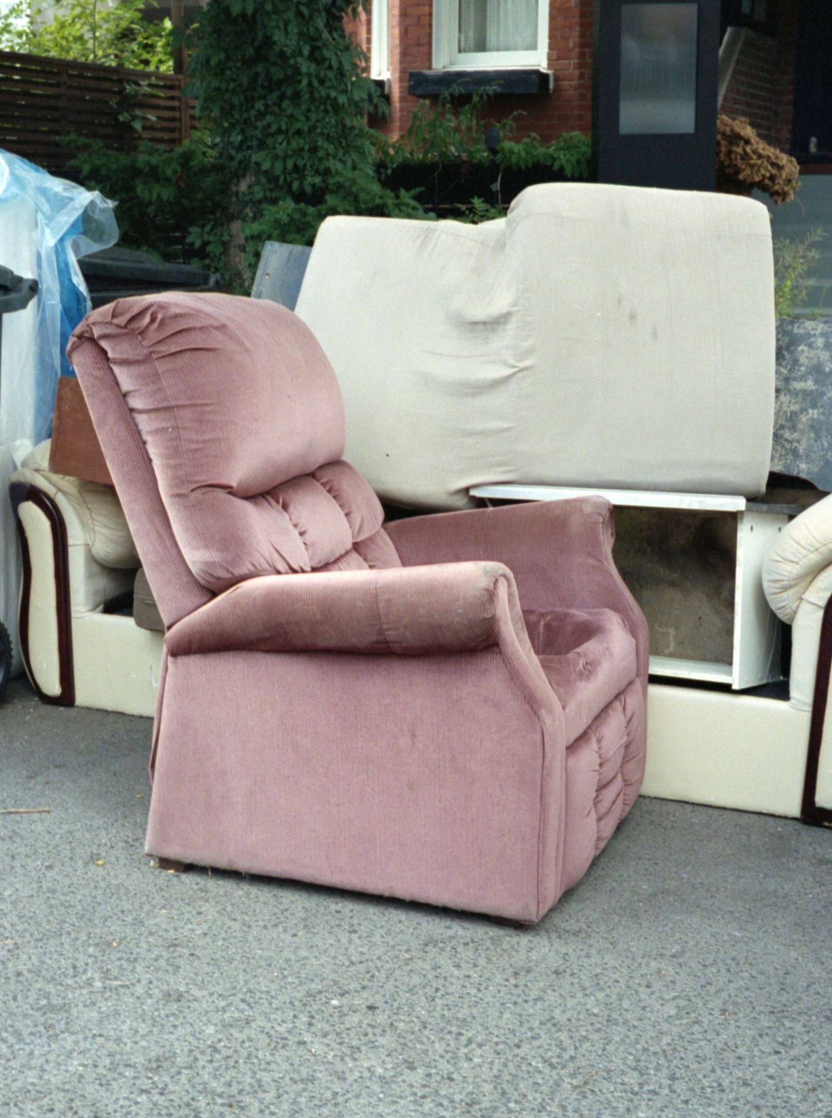 pink sofa chair beside trash bin